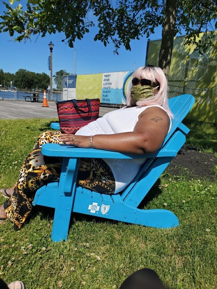 A woman we support relaxes in one of the chairs at Canalside