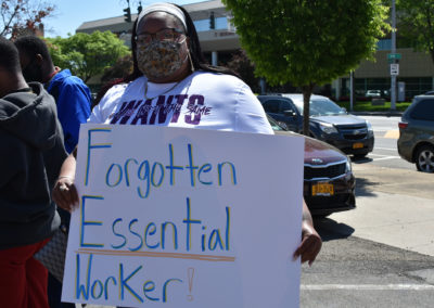 A woman holds a sign