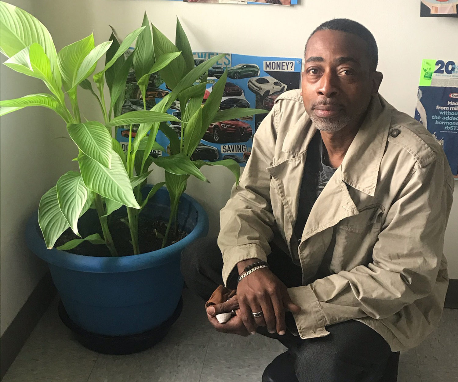 Calvin poses with one of the plants he helped introduce to Community Pre-Voc.